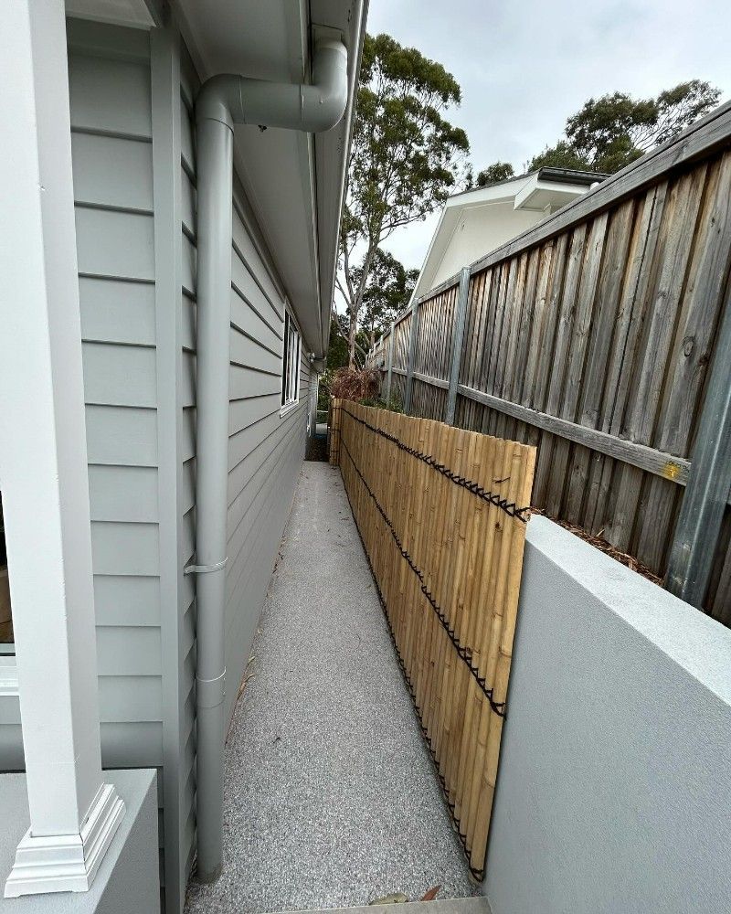 A Wooden Fence Along the Side of a House — Premier Epoxy Flooring Wollongong in Wollongong, NSW