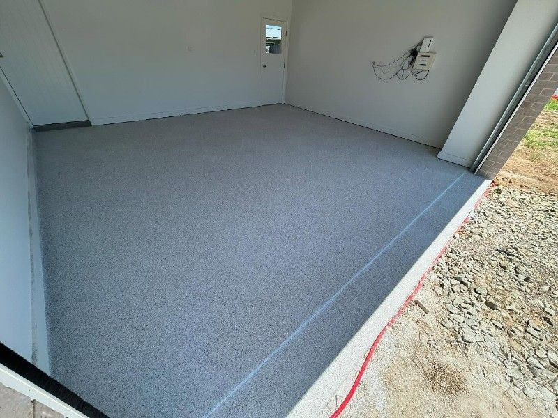 A Garage With a Gray Floor and White Walls — Premier Epoxy Flooring Wollongong in Wollongong, NSW