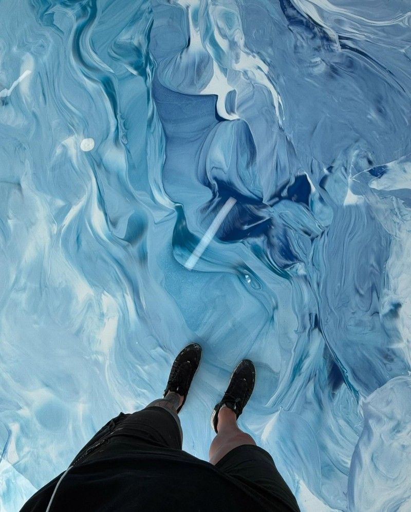A Person Standing on a Blue and White Marble Floor — Premier Epoxy Flooring Wollongong in Wollongong, NSW