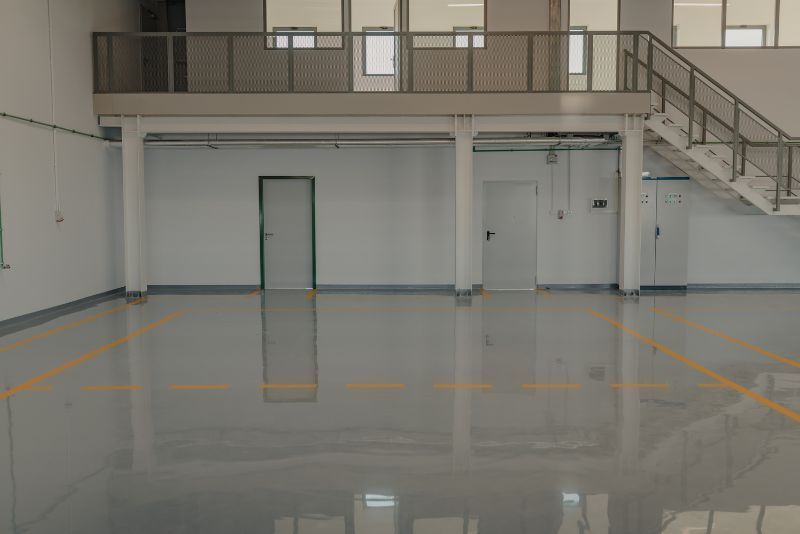 A Large Empty Room With a Balcony and Stairs — Premier Epoxy Flooring Wollongong in Shellharbour, NSW