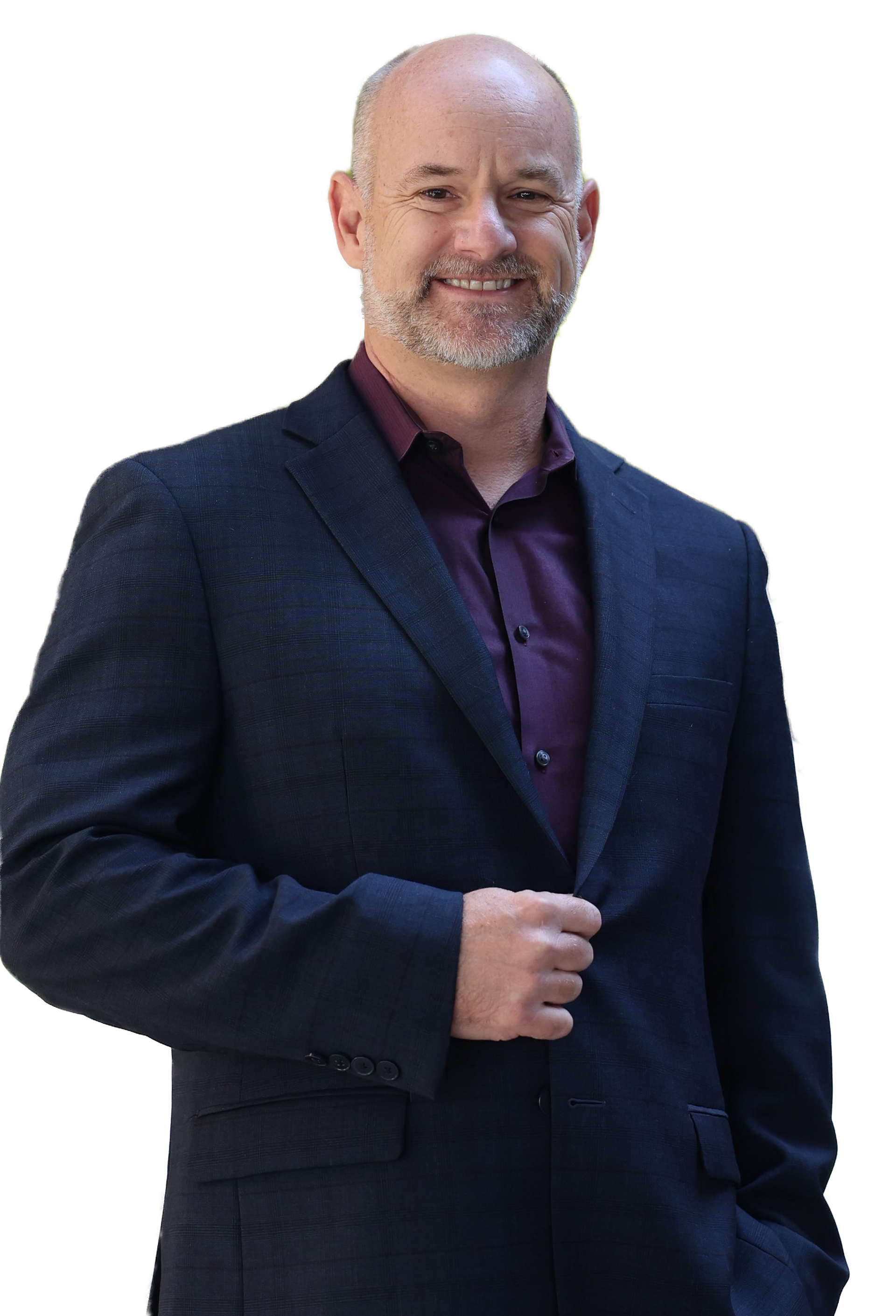 Man in a suit smiles, holding his jacket, against a white backdrop.