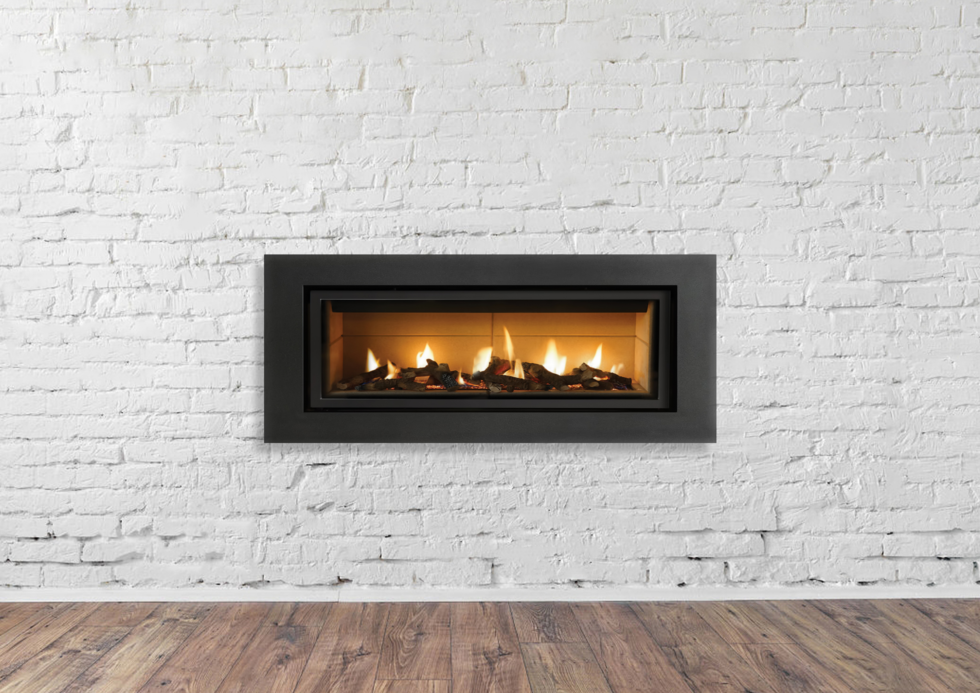 Black fireplace inset into a white brick wall, flames visible.