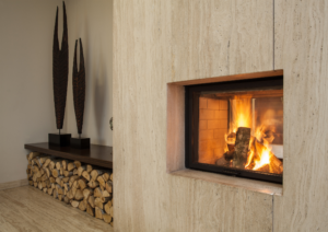 Fireplace with flames and firewood storage in a neutral-toned, modern setting.