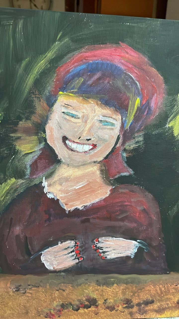 Two women are painting on easels in an art studio.