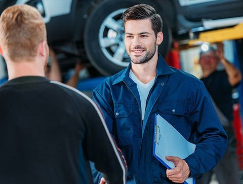 Auto Repair — Mechanic welcoming client in Islip, NY