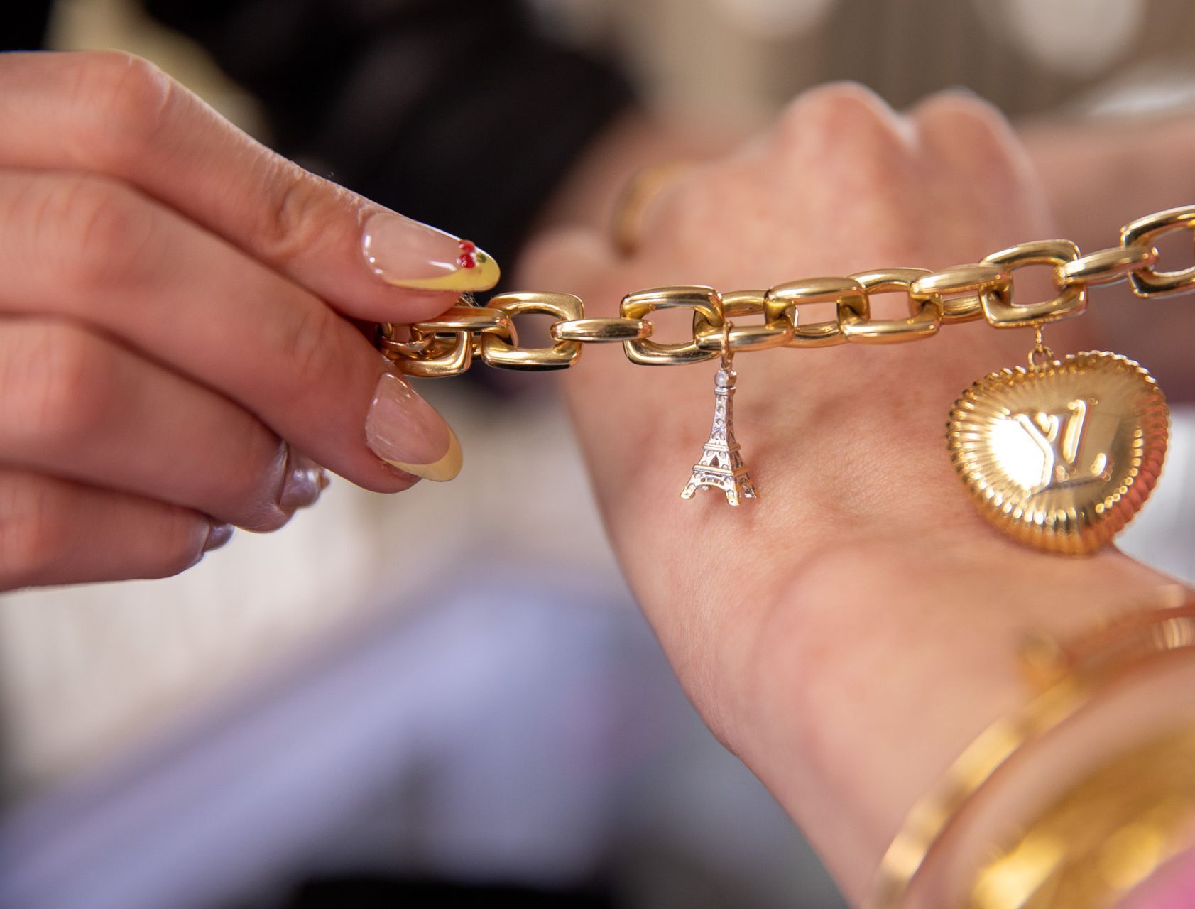 Hands counting $100 bills over a counter. A piece of jewelry sits on a black velvet pad.