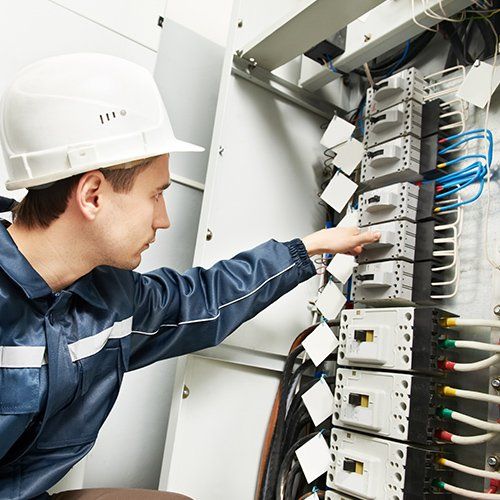 Industrial Electrical Installation — Electrician Working on Electric Cabinet in Des Moines, IA