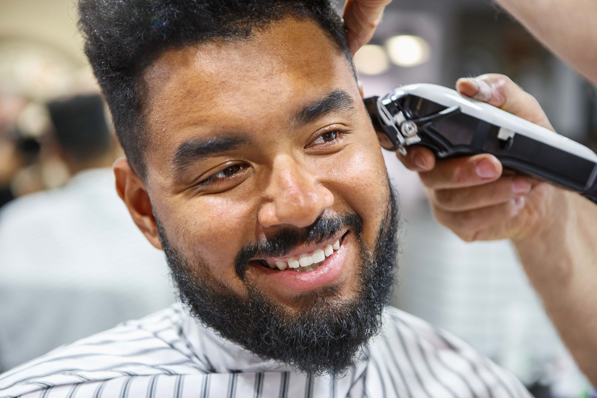 Professional Barber Shaving A Client