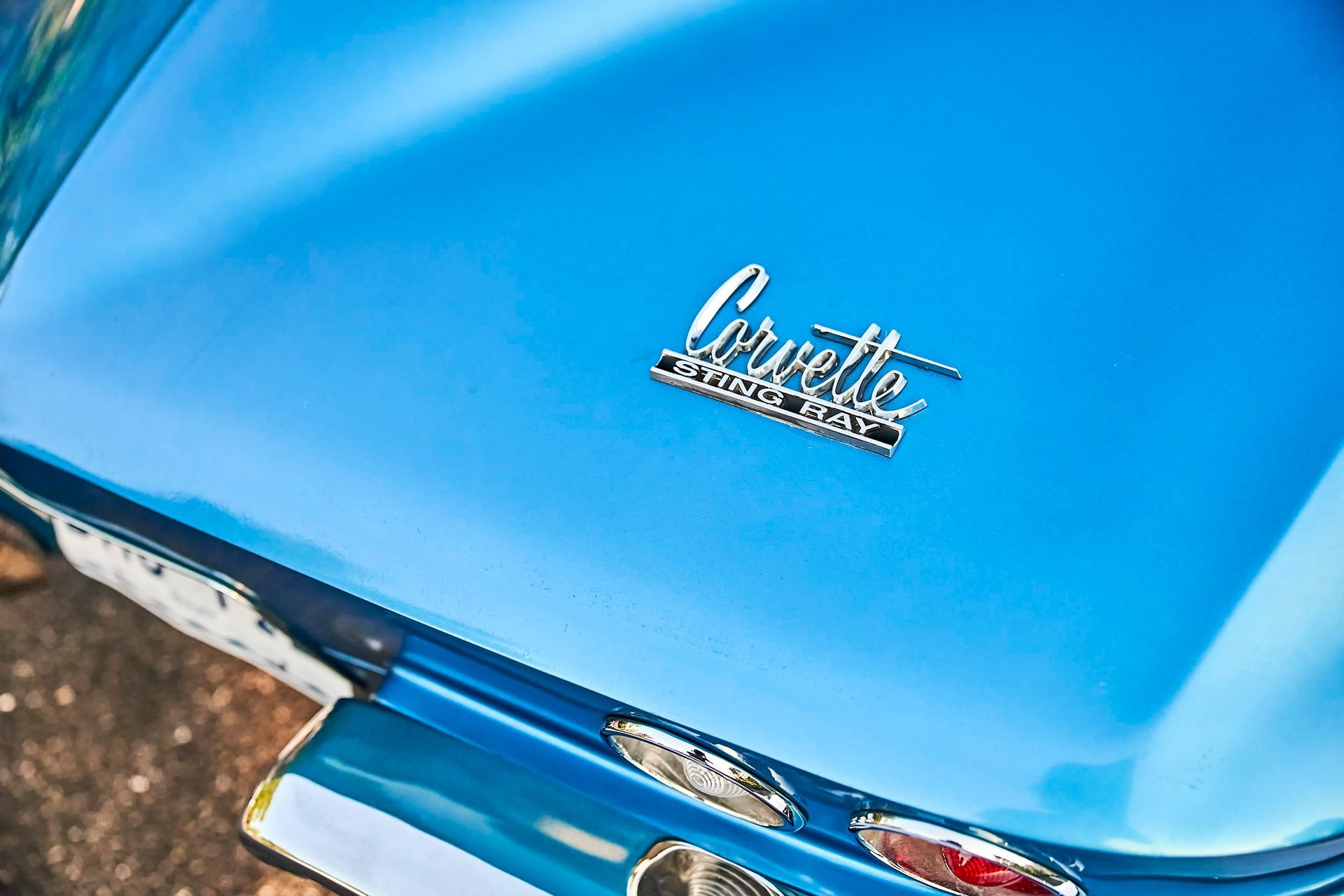 Close-up of a blue classic Corvette's rear with the chrome