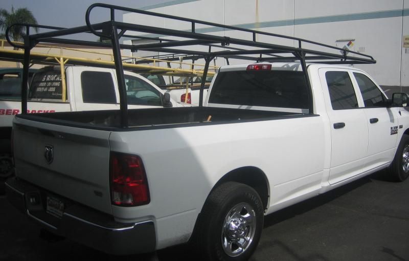 White pickup truck with a black utility rack.