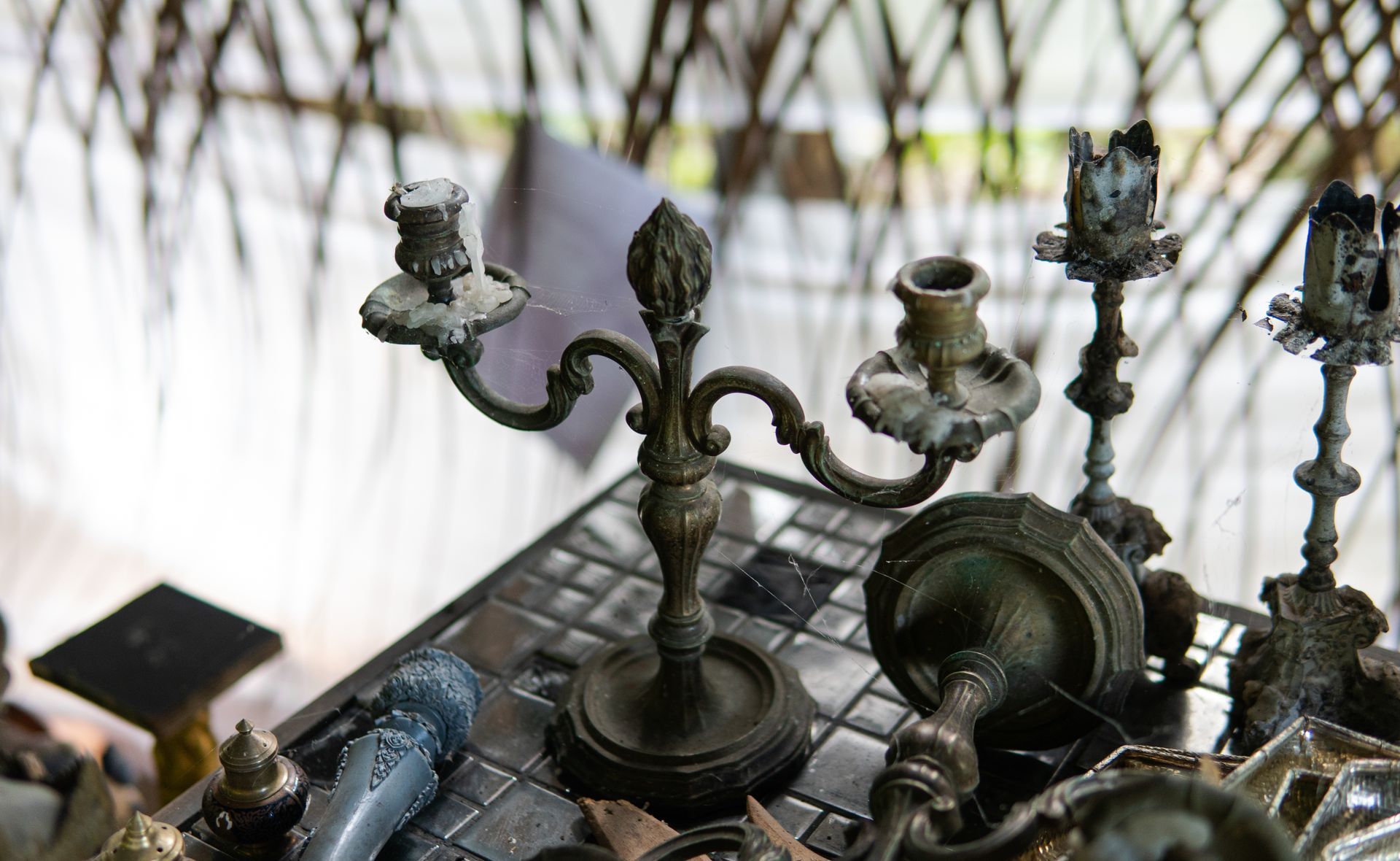 A group of candle holders are sitting on top of a table.