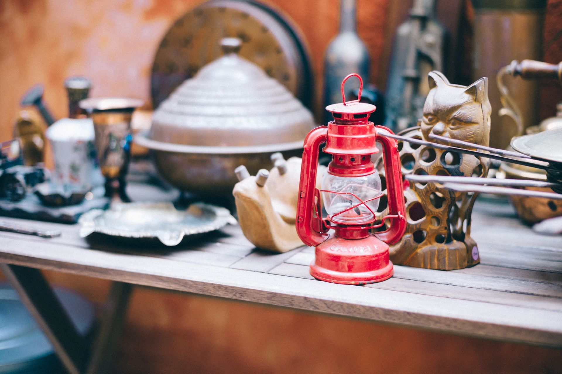 A red lantern is sitting on top of a wooden table.