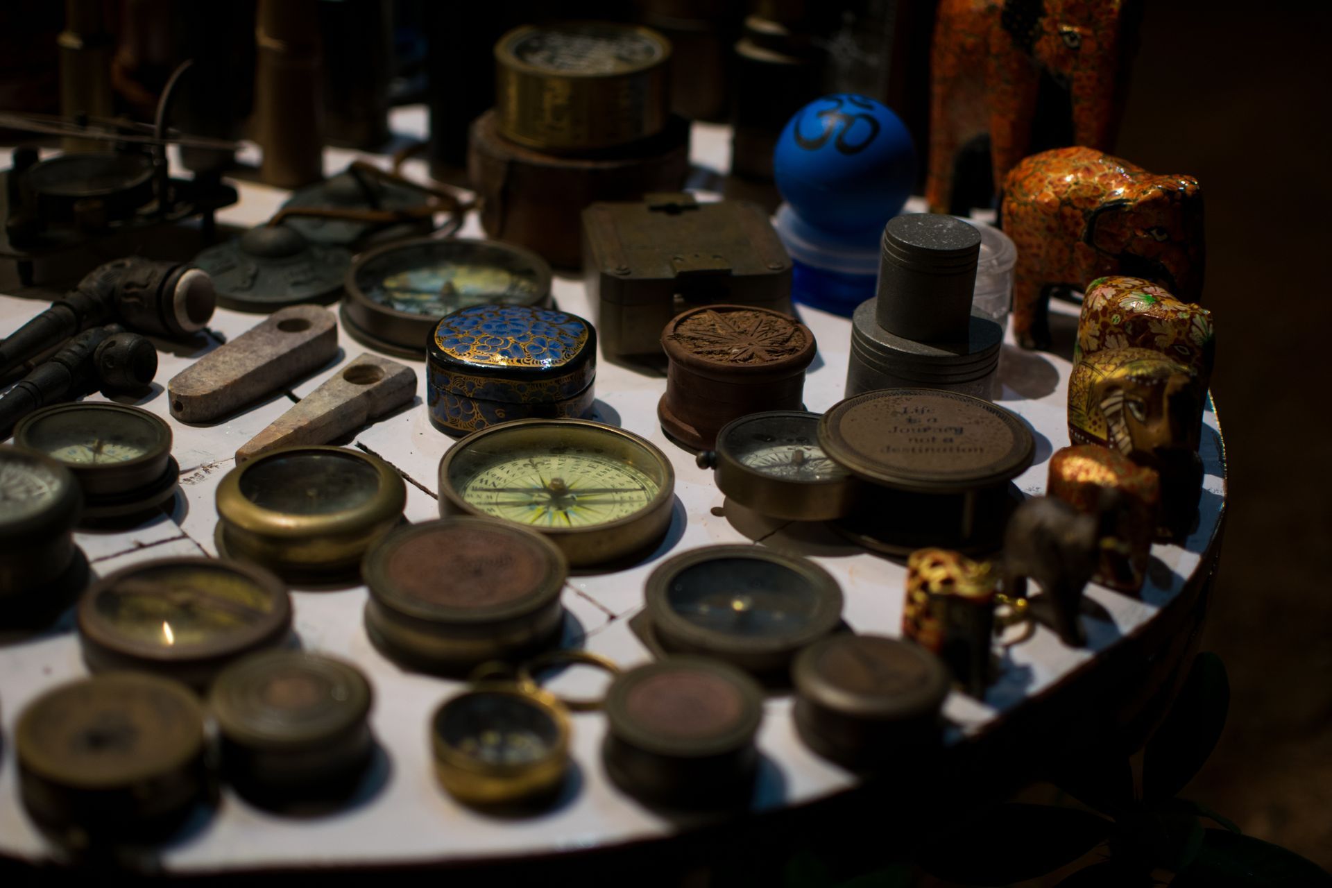 A table with a lot of clocks and compasses on it