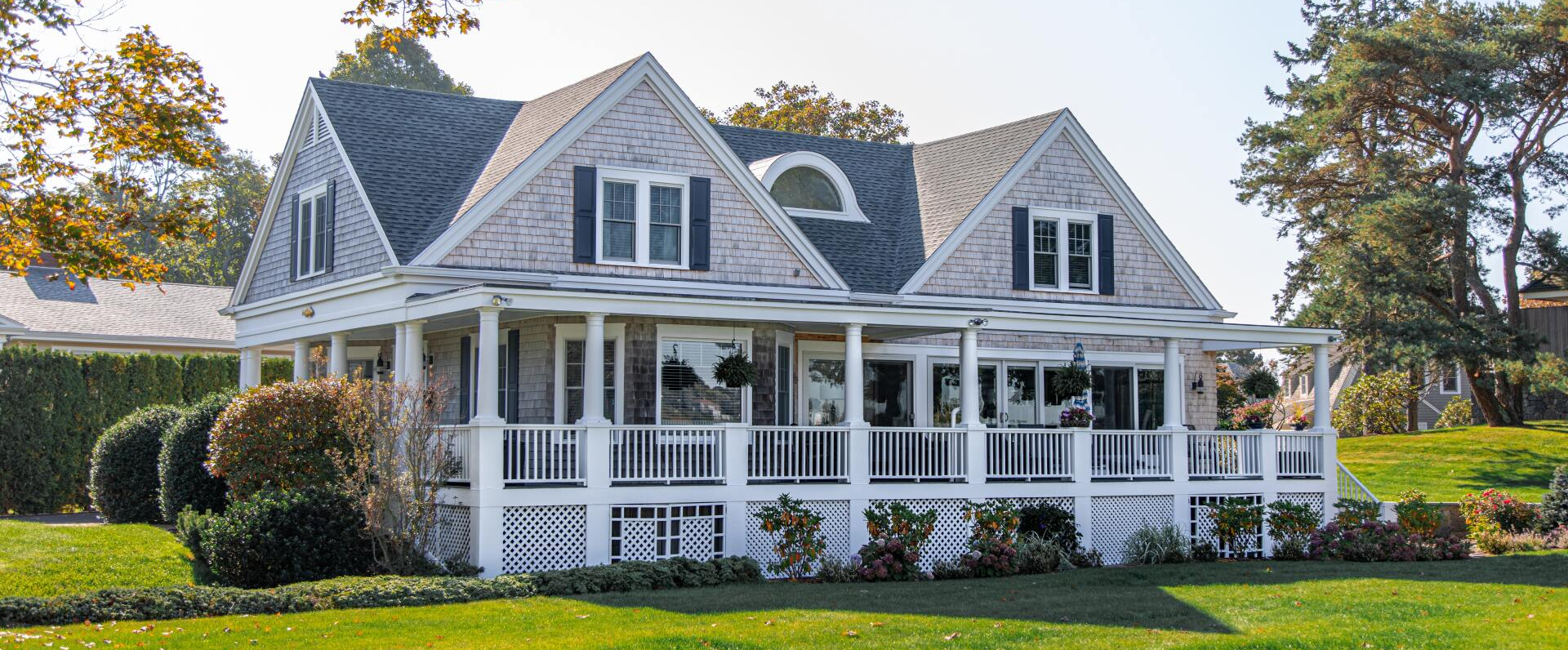 Gray house with big porch and green lawn