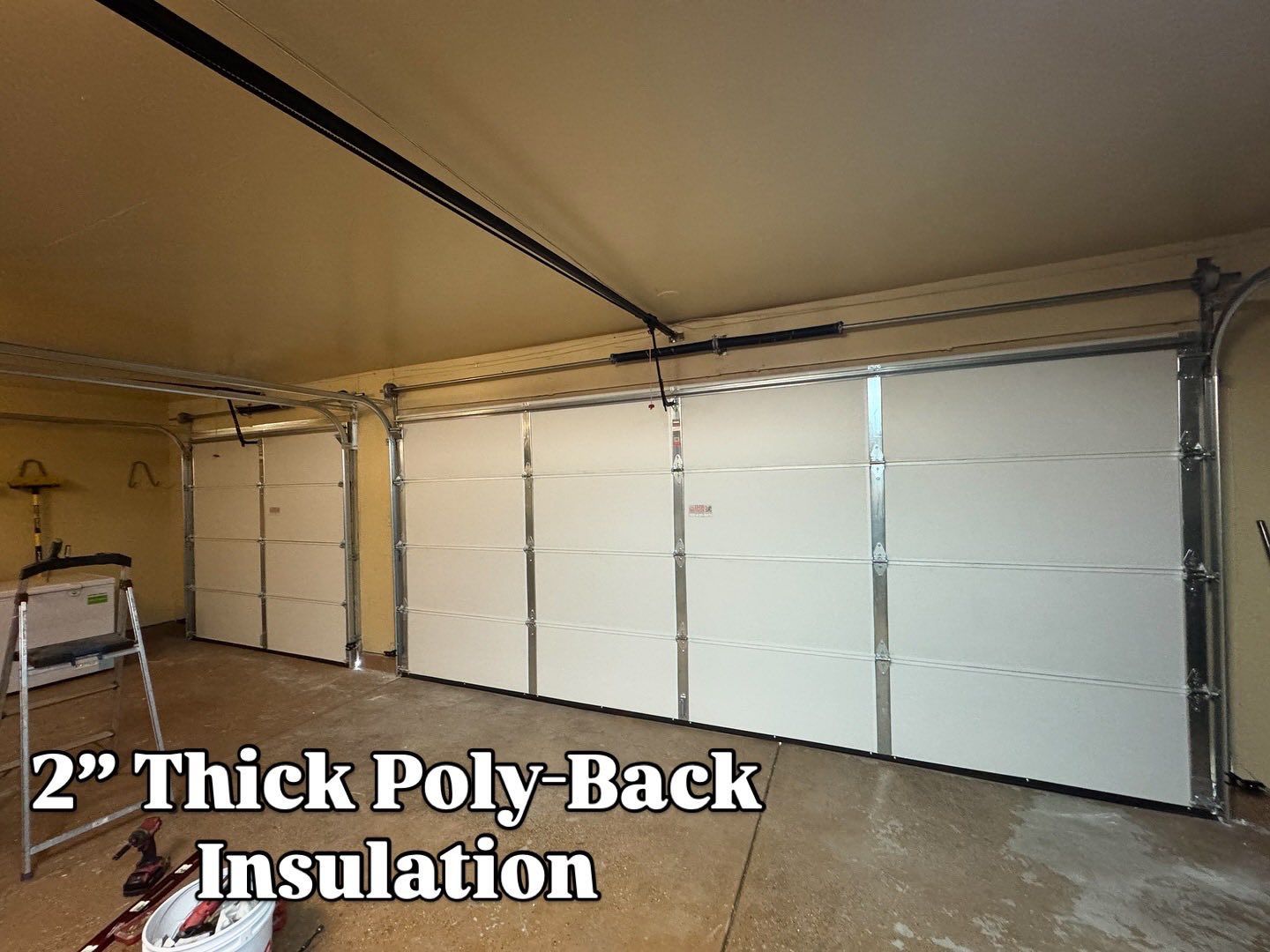 Garage interior with two white garage doors, labeled 