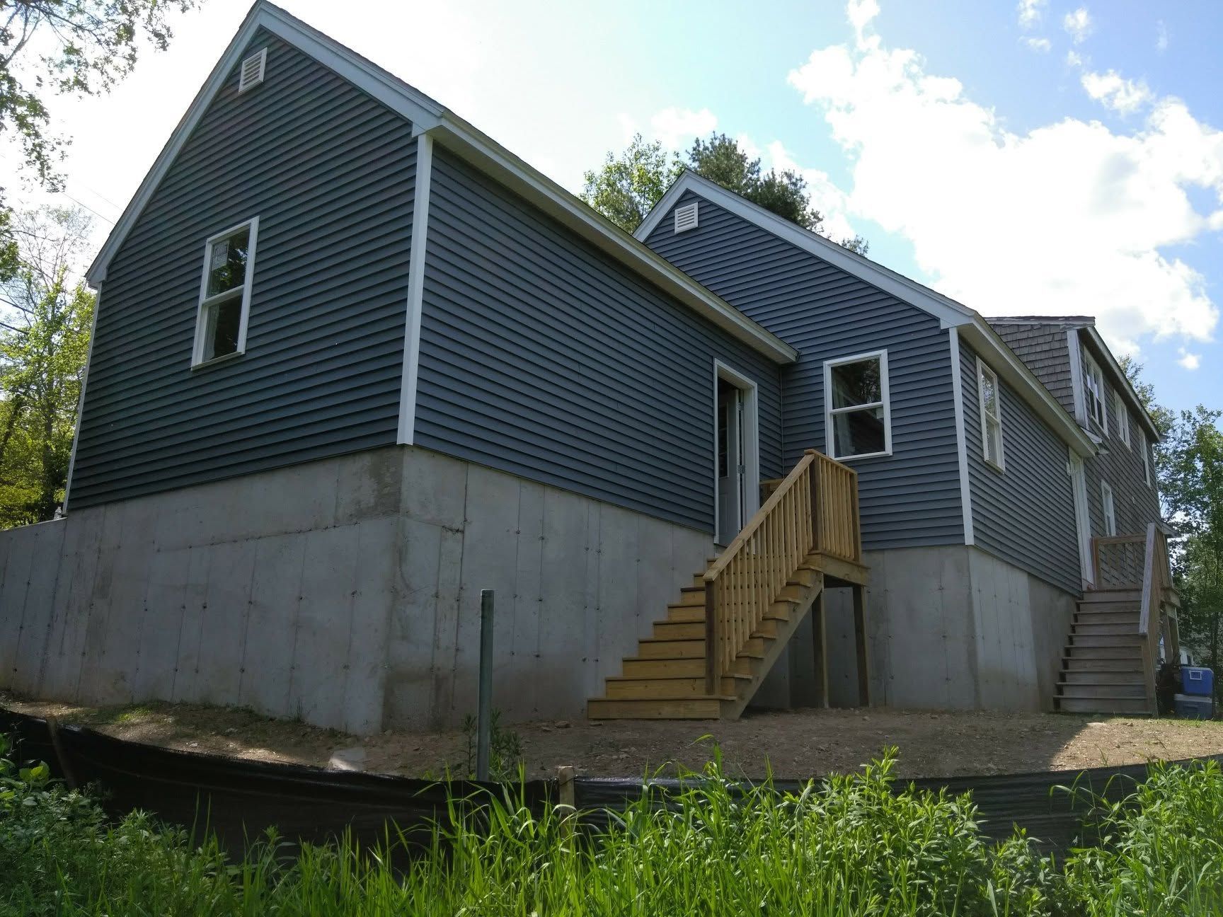 A large house with a wooden deck and stairs