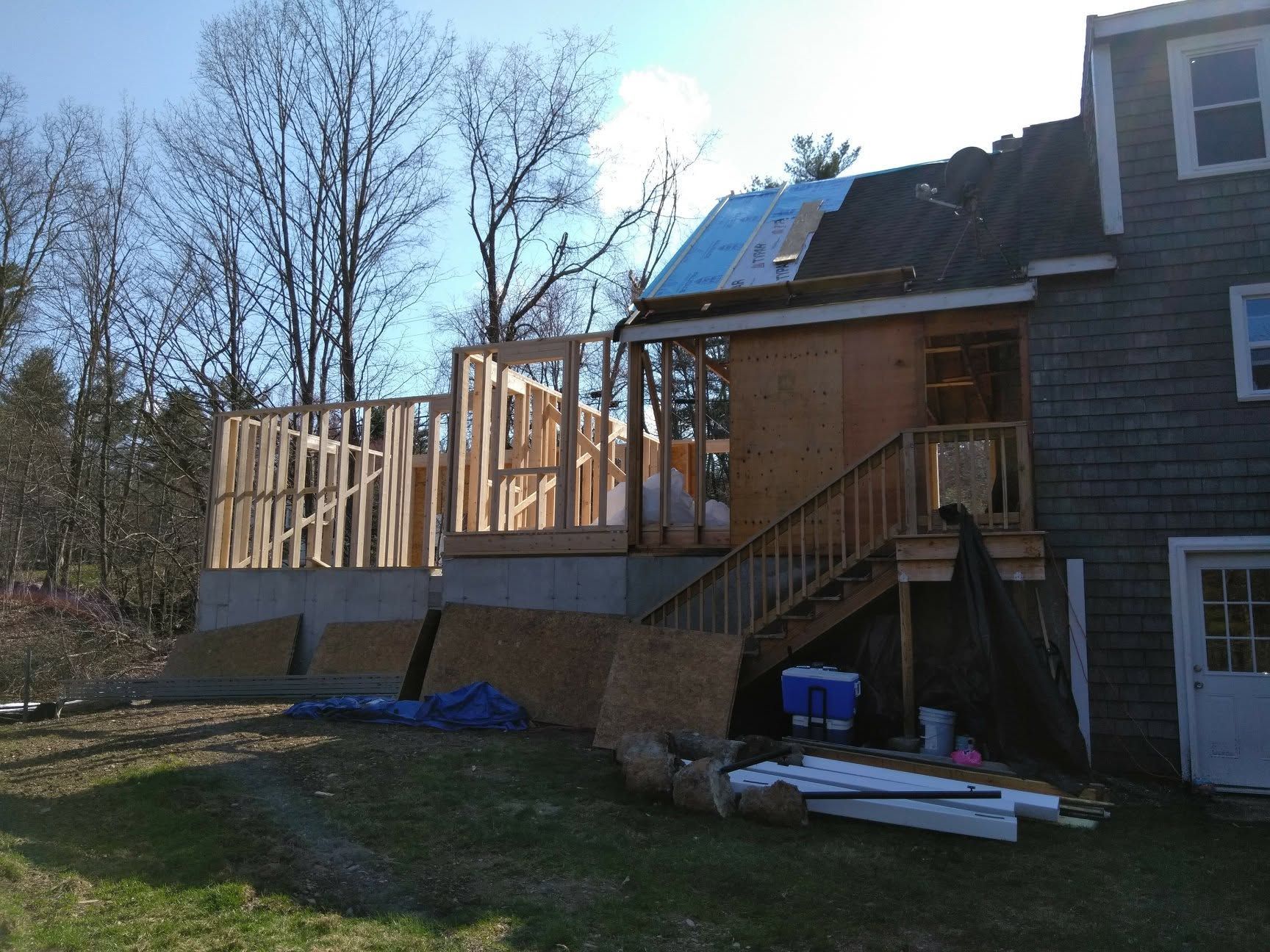 A house is being remodeled with a deck and stairs