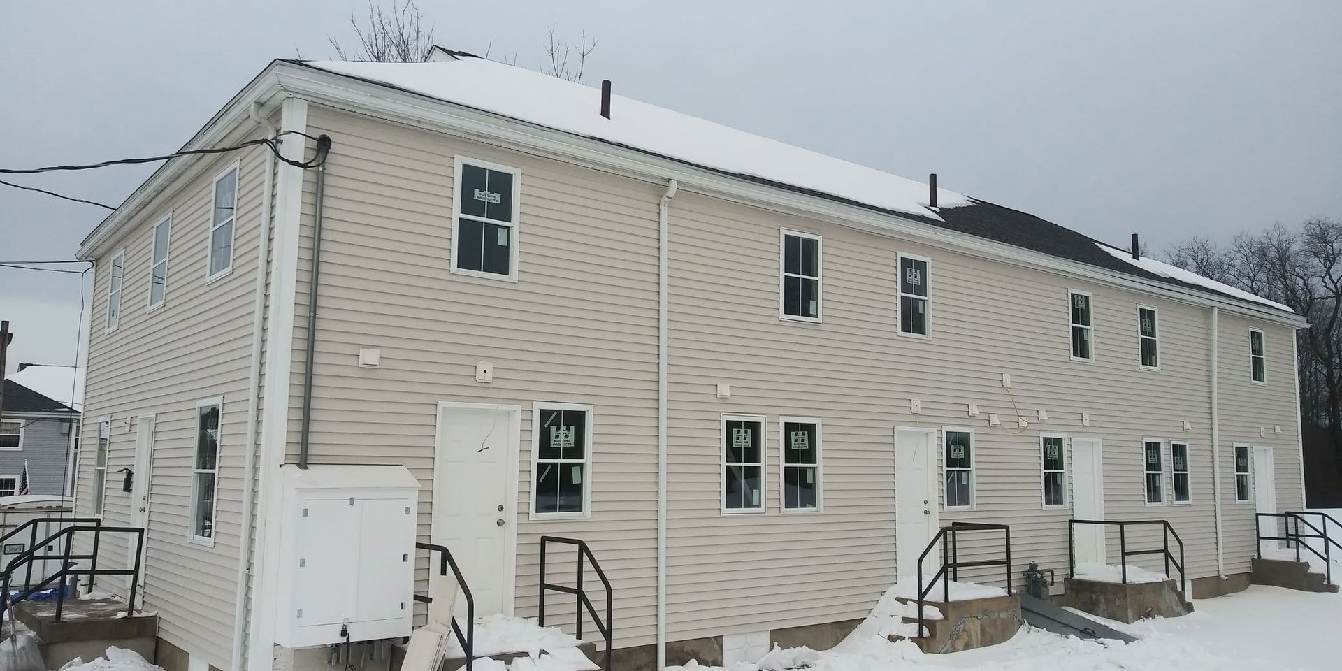 A building with a lot of windows is covered in snow