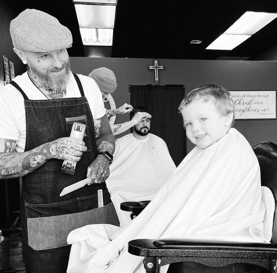 Barber Tommy cutting a boy's hair at the Lion of Judah Barbershop in Wanamassa, NJ 07712