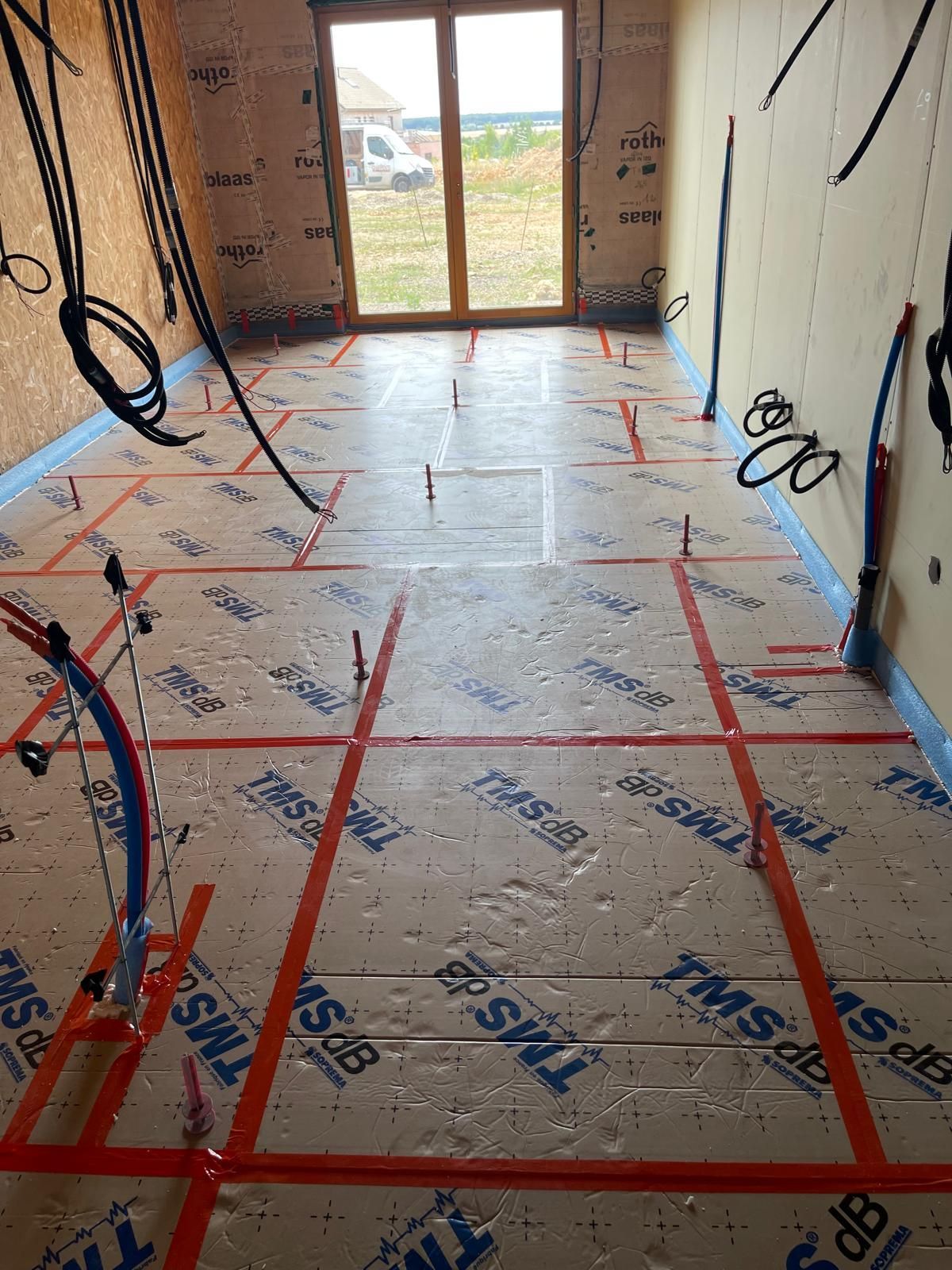 Une pièce avec beaucoup de fils et de ruban adhésif sur le sol.