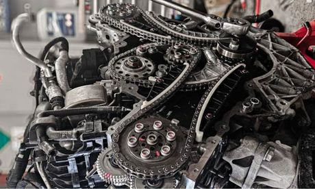 Engine gears, chains, and sprockets exposed during repair.