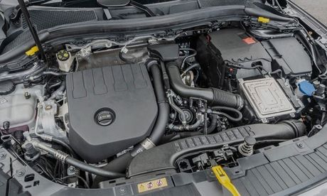 Car engine bay, black cover, various components, and fluids visible.