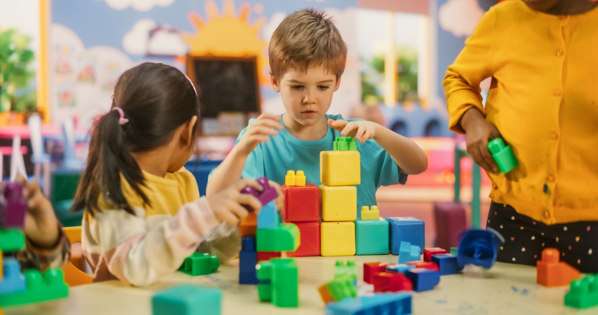 A group of kids building blocks at an outside school hours child care.