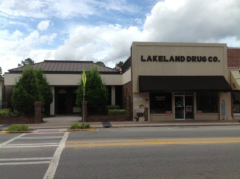 Lakeland drug co. is located on the corner of a street