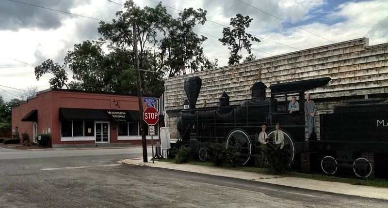 A train is parked in front of a stop sign