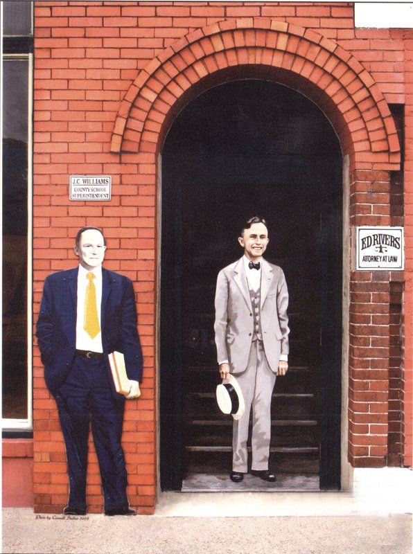 Two men standing in front of a brick building with a sign that says pioneers