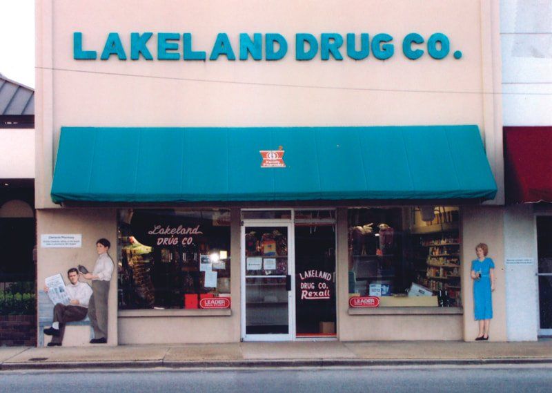 Lakeland drug co. has a blue awning on the front