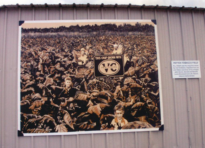 A black and white photo of a crowd with a sign that says vc