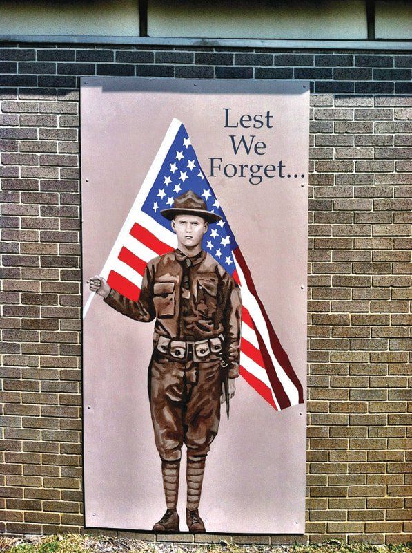 A painting of a soldier holding an american flag says lest we forget