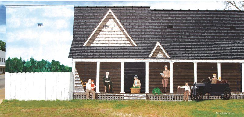 A model of a house with people on the porch