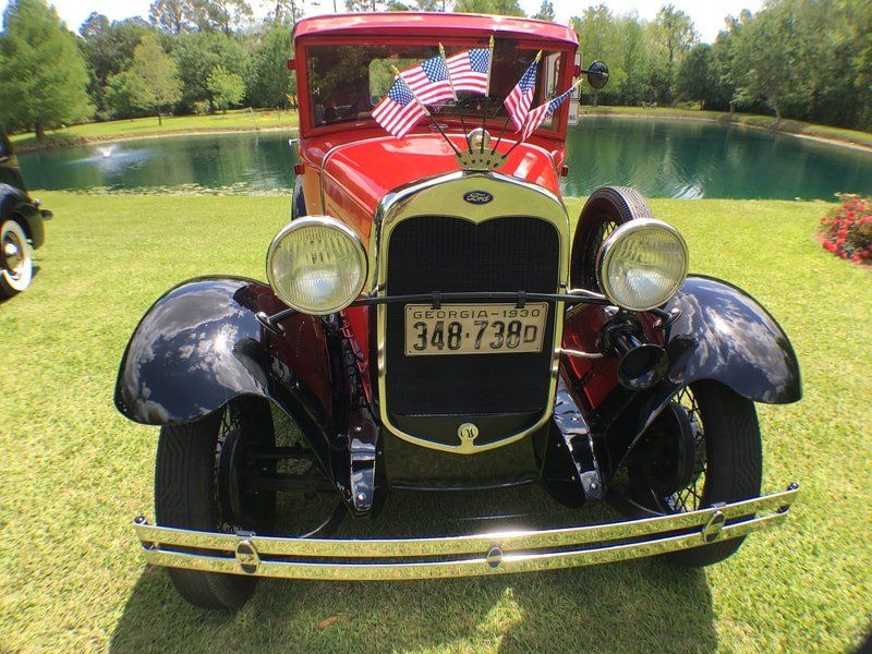 A red car with a license plate that says 348-739d