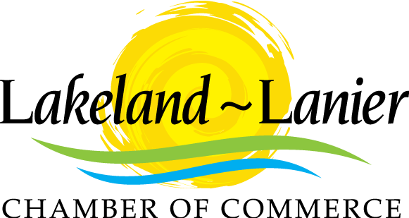 The lakeland lanier chamber of commerce logo has a yellow sun and green waves.