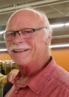 A man with glasses and a mustache is smiling for the camera.