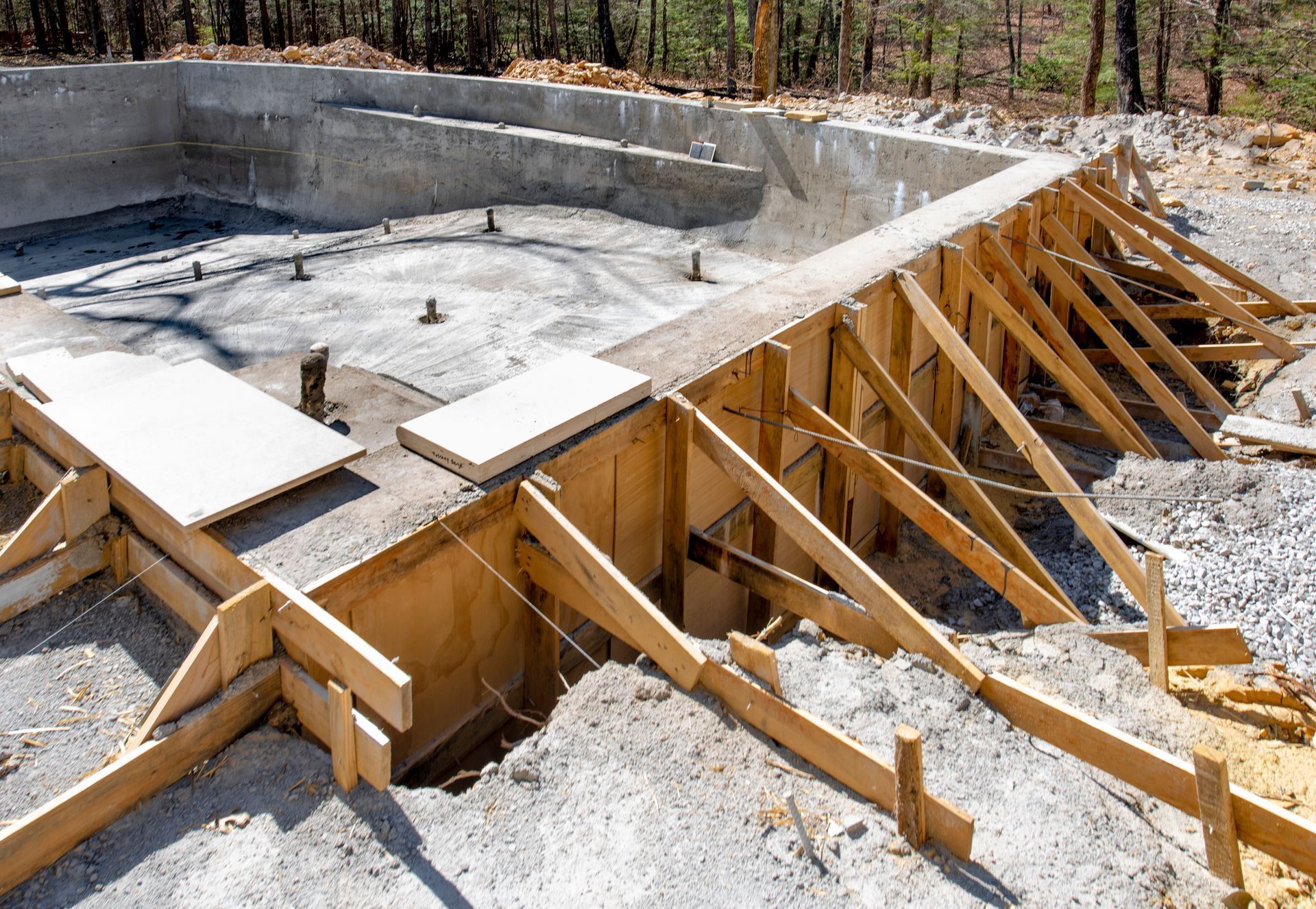 Pool and patio of a villa with people lounging; blue water, cream-colored walls, mountains in background. Pool and patio of a villa with people lounging; blue water, cream-colored walls, mountains in background.