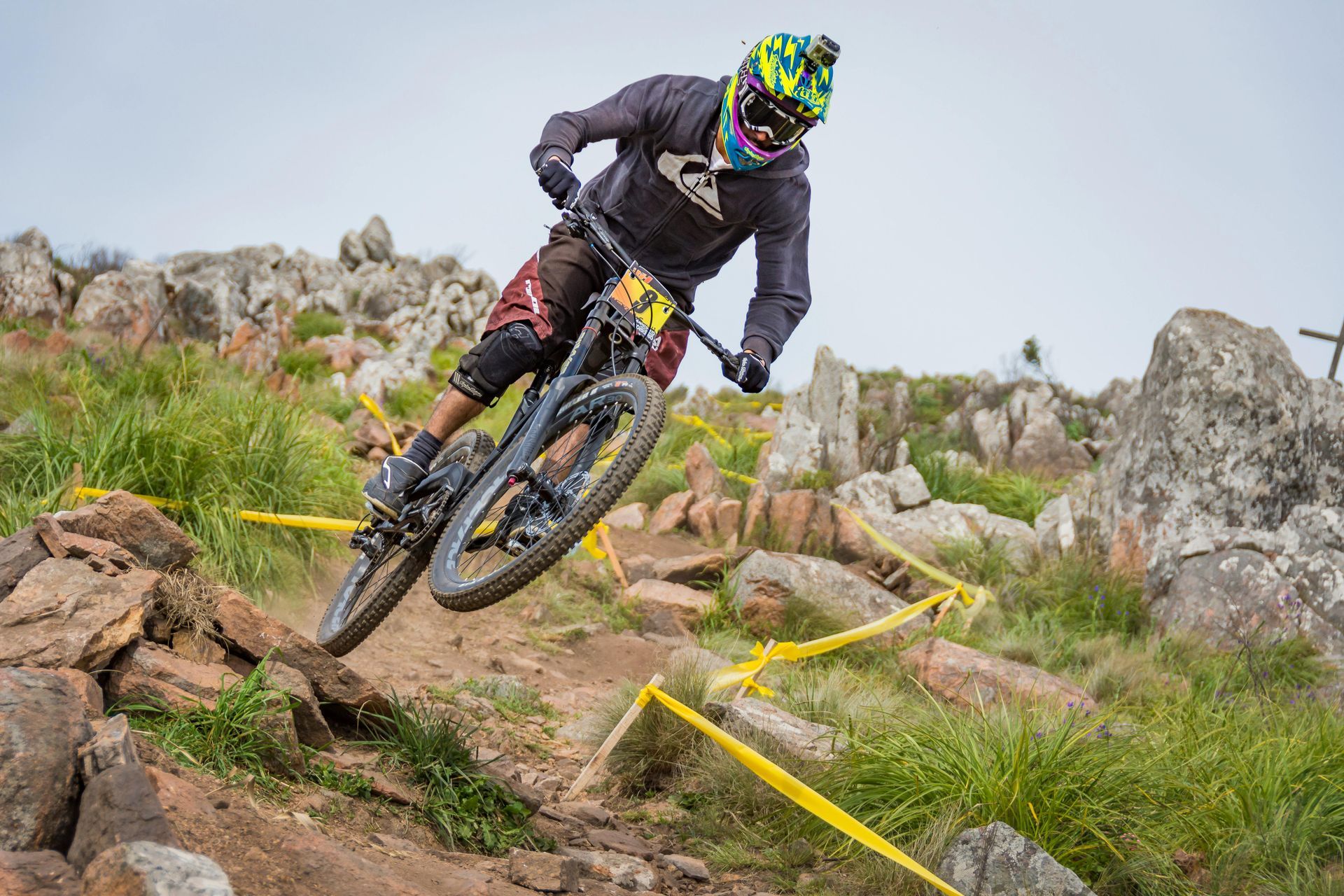 A man is riding a mountain bike down a rocky trail.