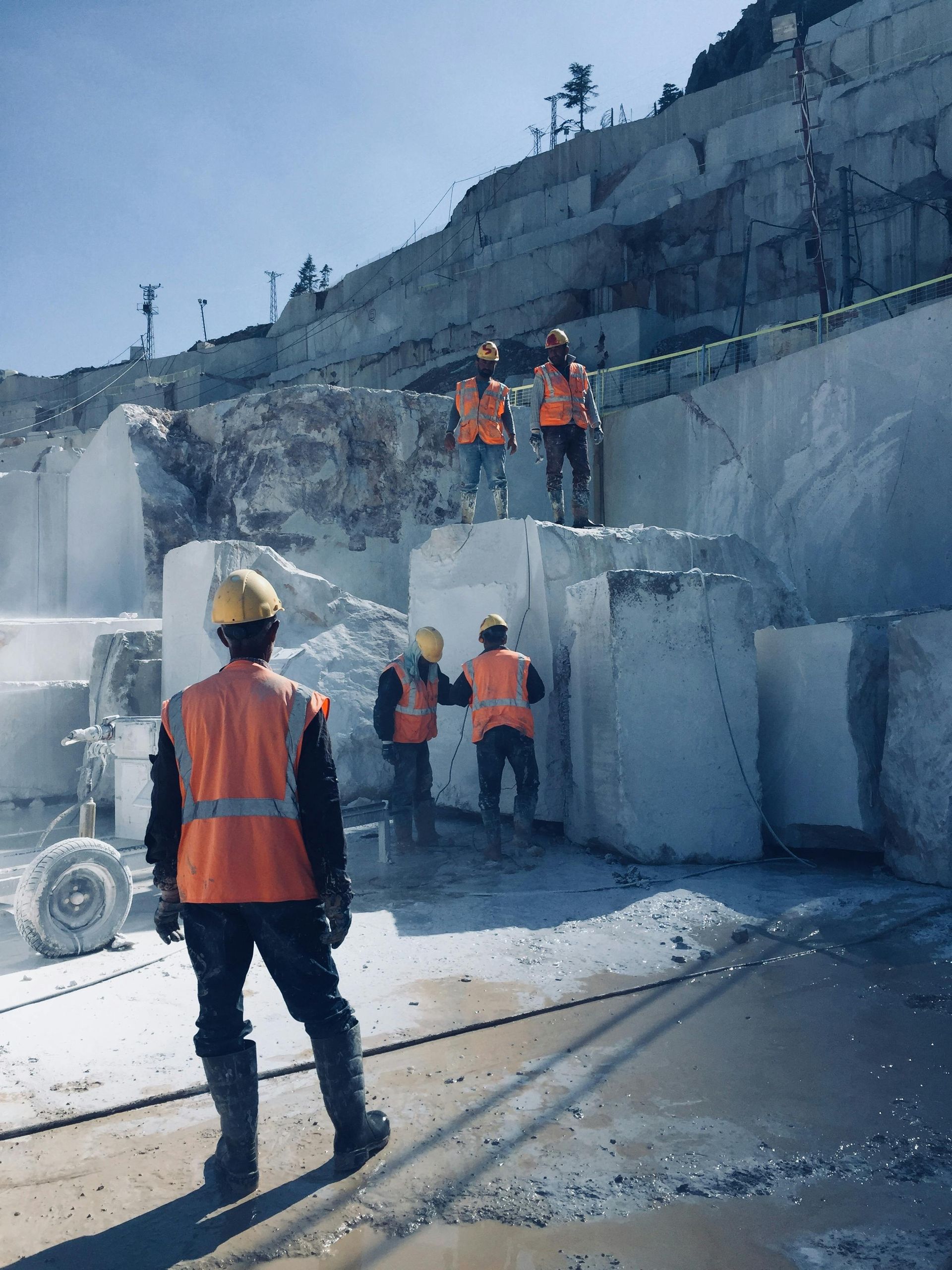 A group of construction workers are working in a quarry