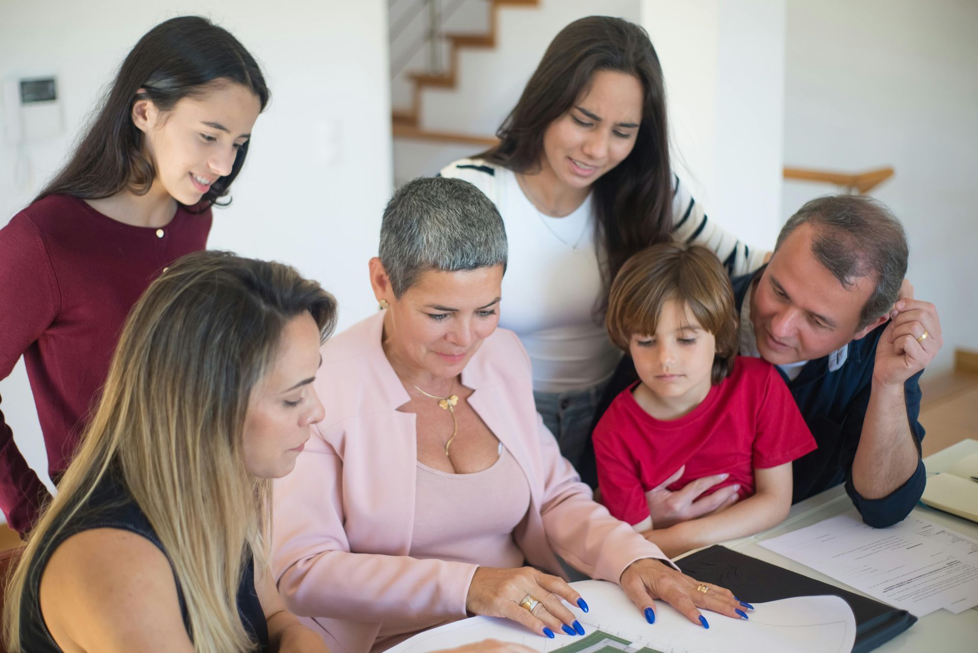 A group of people are sitting around a table looking at Term Life insurance options.