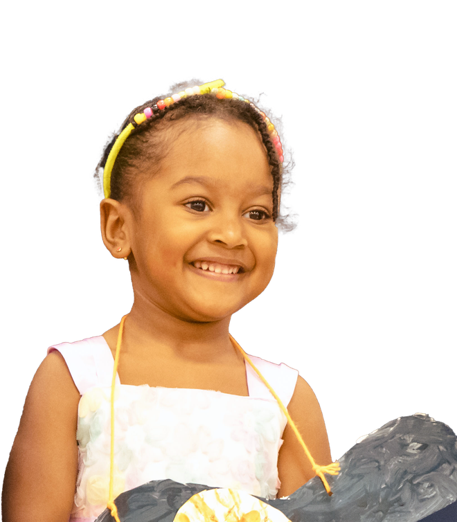 Woman with short, wavy gray hair wearing glasses, smiling, lit by sunlight.