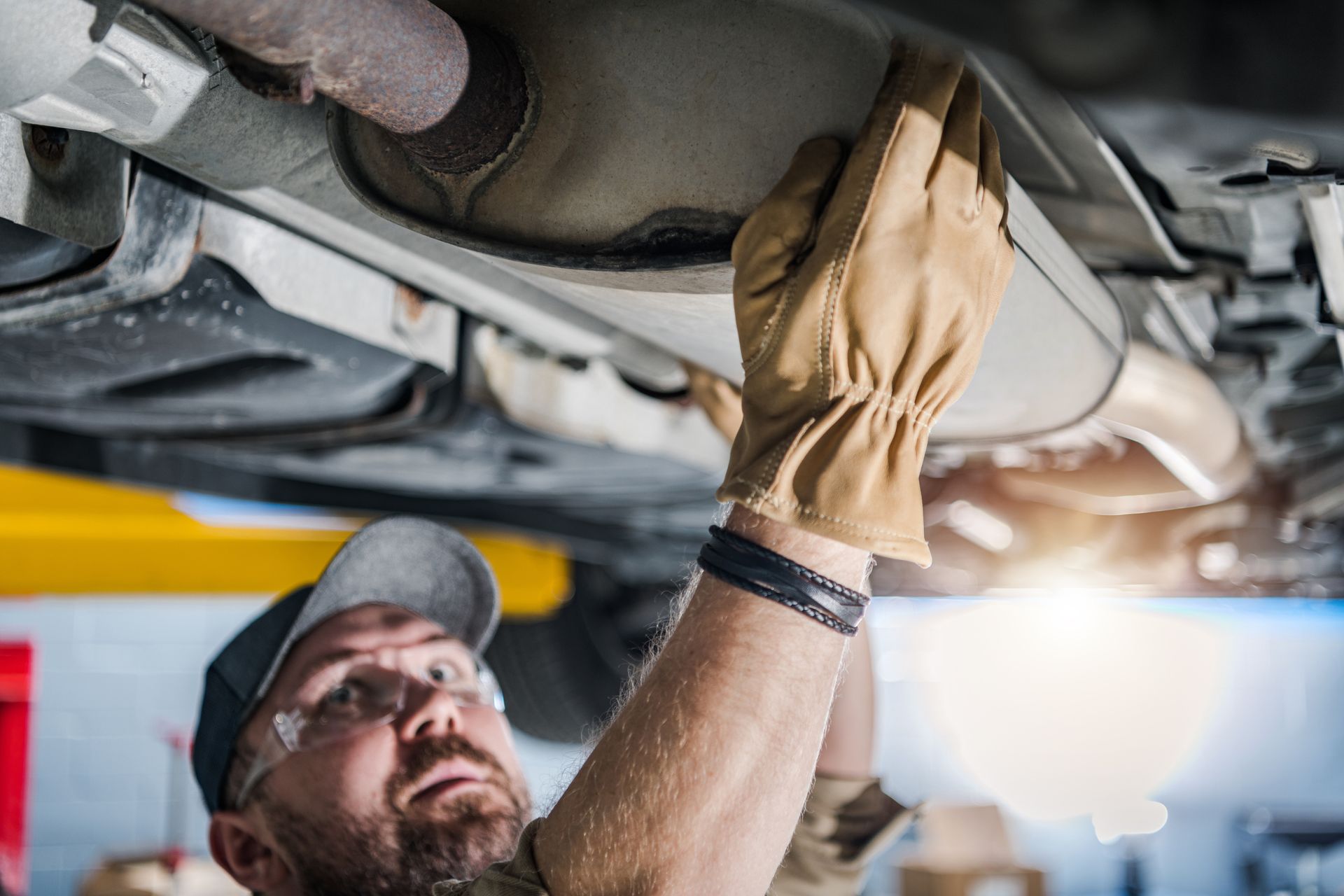 mechanic working on a catalytic converter