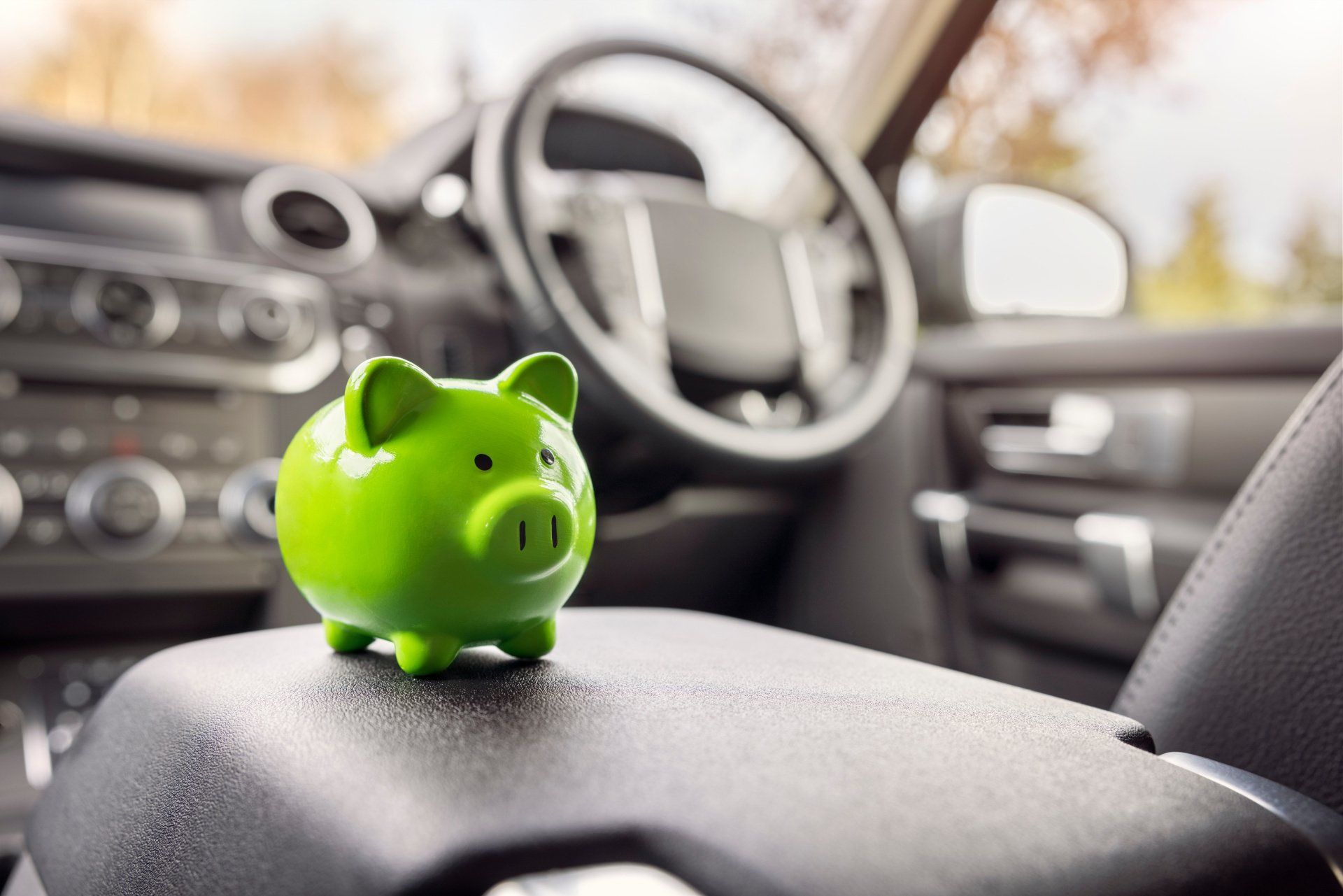 green piggy bank in car