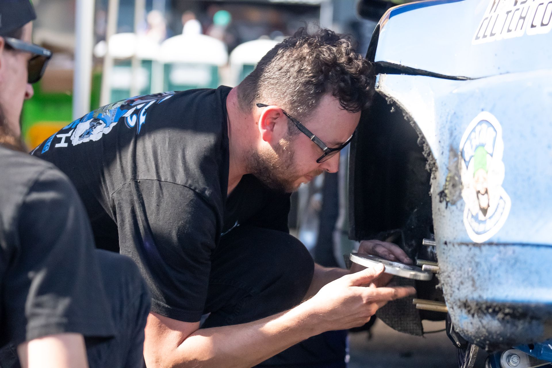 Mike Klamm is working on a car in a garage.