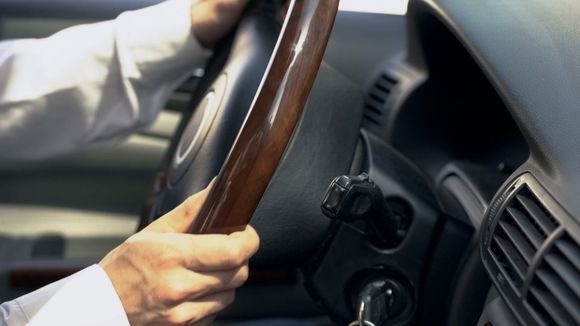 man holding a steering wheel