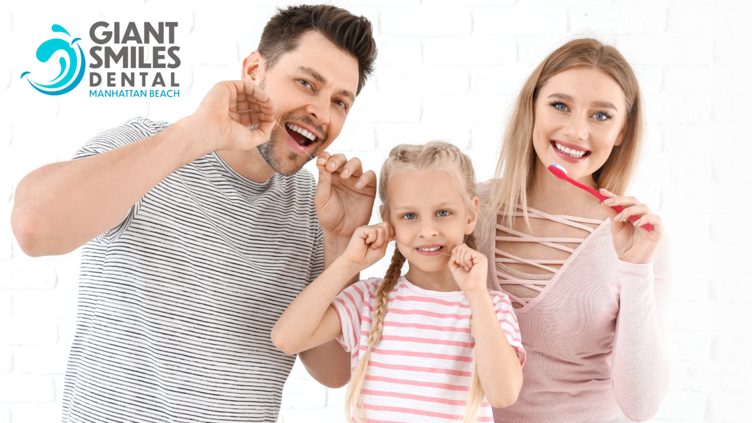 A man , woman and child are brushing their teeth together.