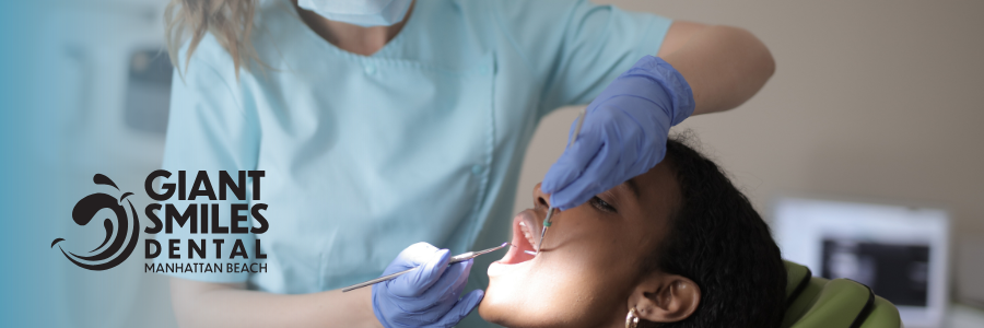 A dentist is holding a model of a person 's teeth with tweezers.