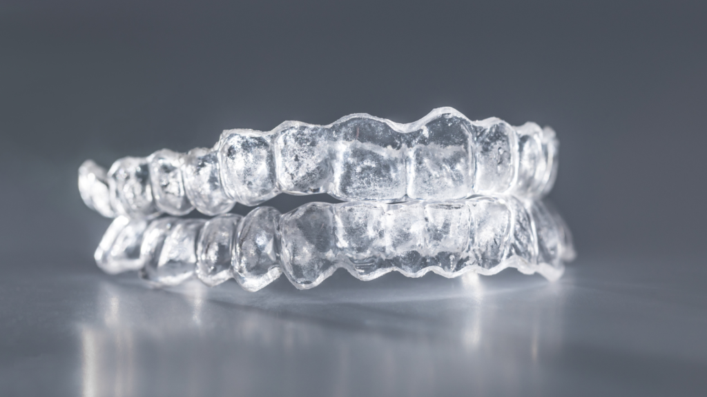 A pair of clear braces sitting on top of each other on a table.