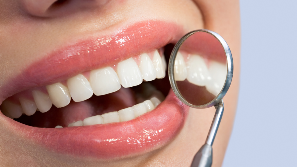 A woman is getting her teeth examined by a dentist.